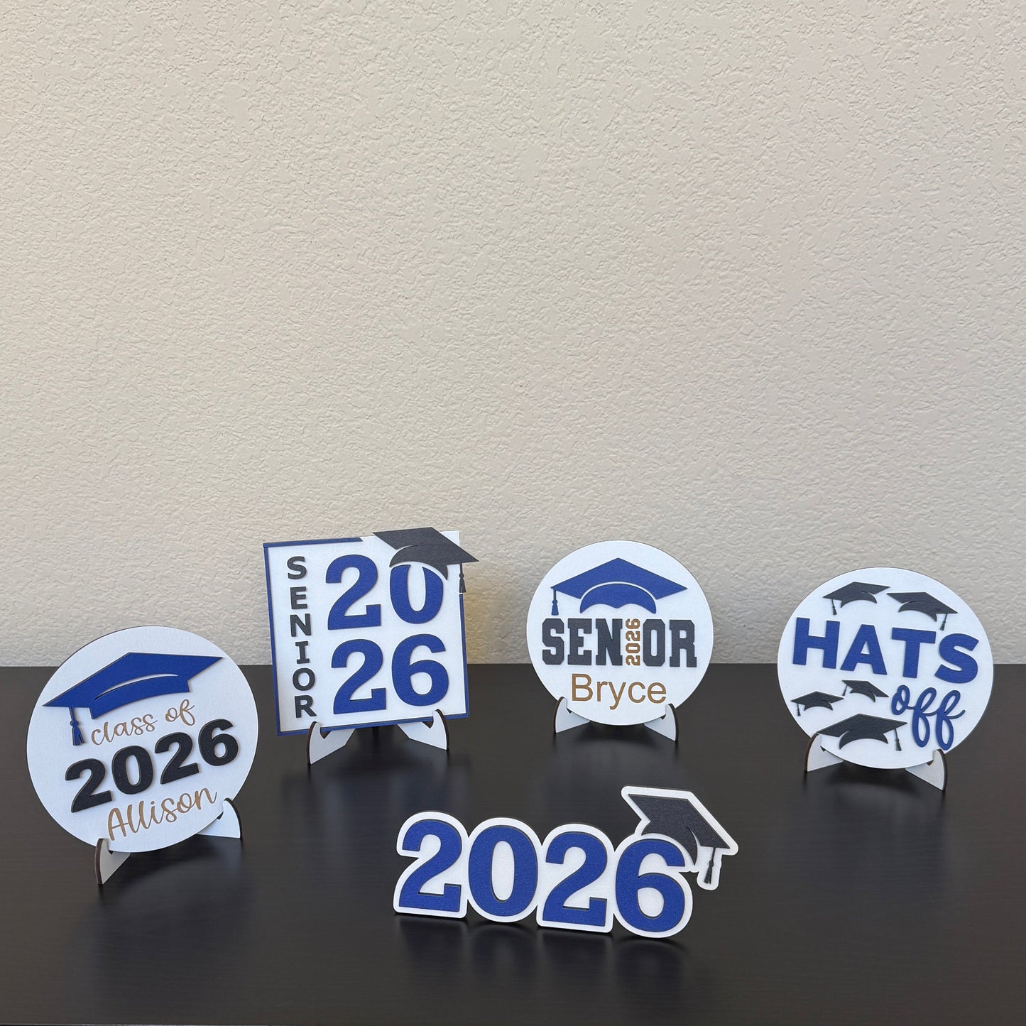 Half Turn Designs Class of 2026 sign collection in white with blue accents, graduation party decor for high school seniors