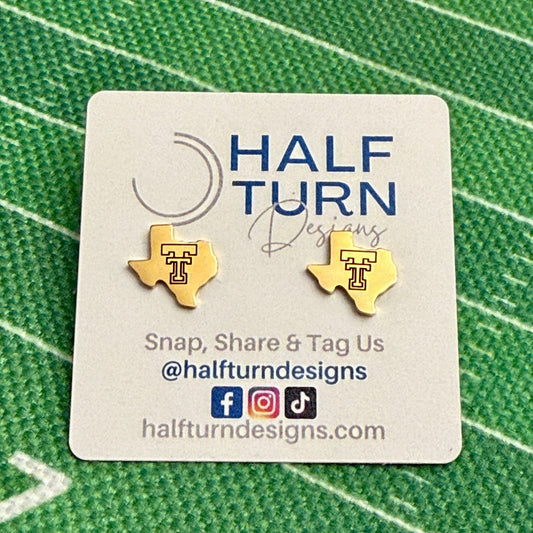 Close-up of gold-tone Texas-shaped Texas Tech stud earrings engraved with the TTU Double T logo