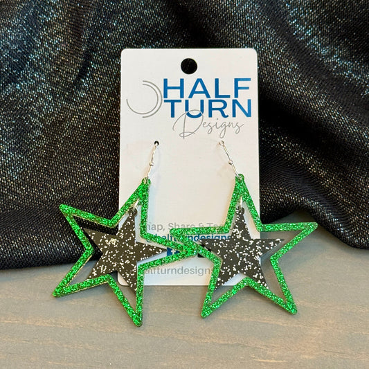 Green and Black Stars earrings in glitter acrylic with silver earrings hooks on Half Turn Designs earring card.