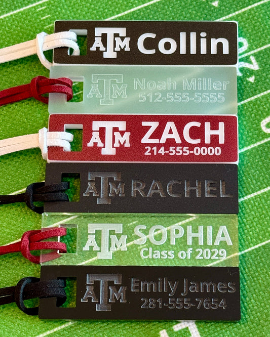 Officially licensed Texas A&M luggage and bag tags in rectangular shape, measuring 2.75x0.75". These acrylic luggage and bag tags are personalized with 1-2 lines of text and come in 1/8" or 1/4" width. Luggage tag colors include Clear, Frosted, Opaque Black, Shiny Black, Maroon that engraves white and Black that engraves white.