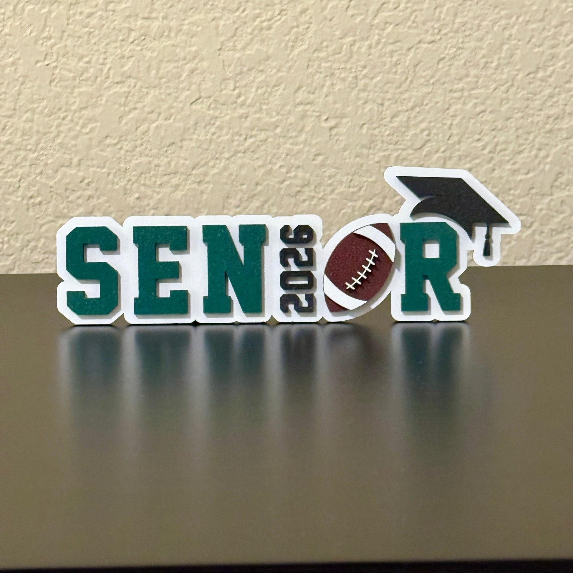 Graduation sign for Class of 2026 High School Senior Basketball Player for Senior Tables, Football Banquet and graduation party. Shown here in White Wood with Dark Green Accent