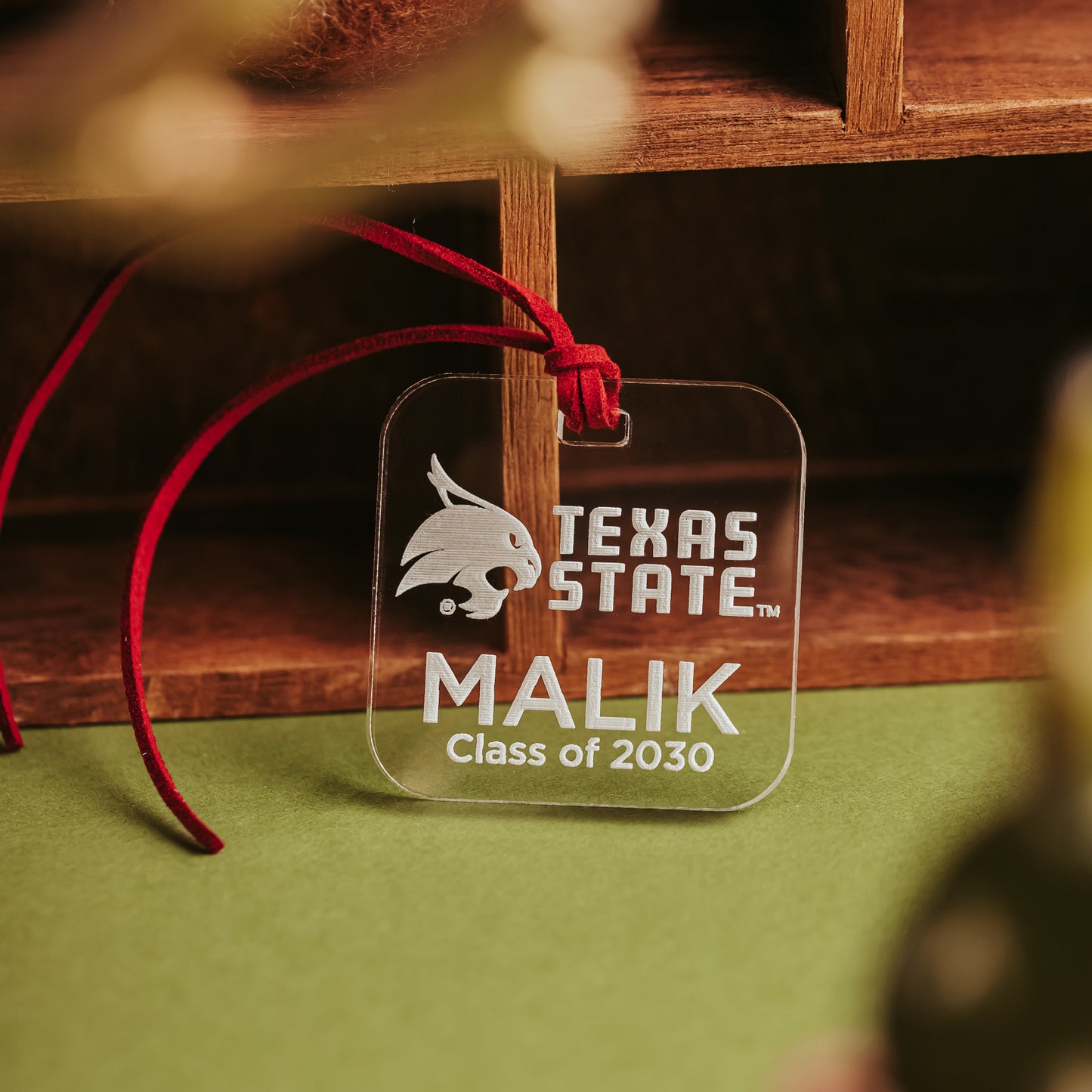 Personalized Texas State luggage tag in clear acrylic, engraved with the Bobcat logo, TEXAS STATE wordmark, a name, and graduation year.