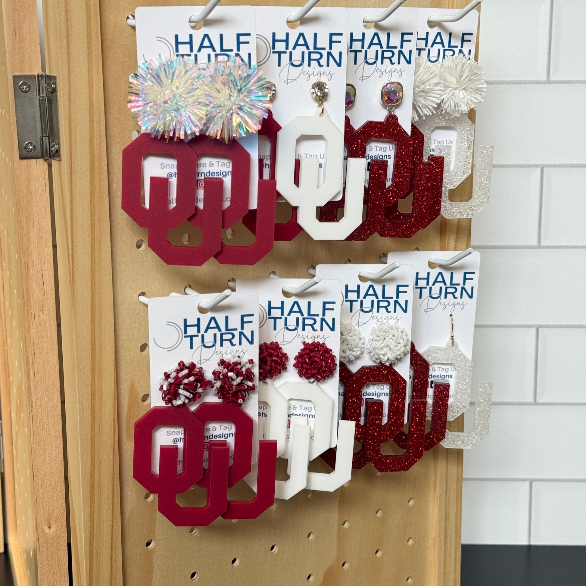Half Turn Designs Collection of Officially Licensed University of Oklahoma Large OU Earrings in crimson, white, crimson glitter or white glitter acrylic. Available in a variety of hypoallergenic earrings hooks and toppers.