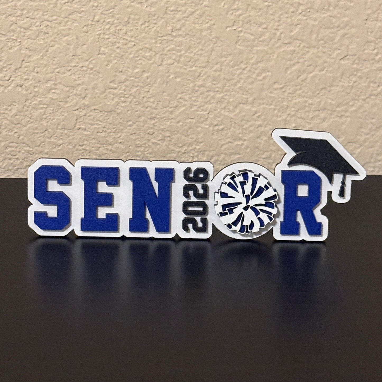 High School Pom, Cheer & Drill Team Sign. Base is white wood. Spells Senior with the Class year as the "I" and  a Pom Pom as the "O"