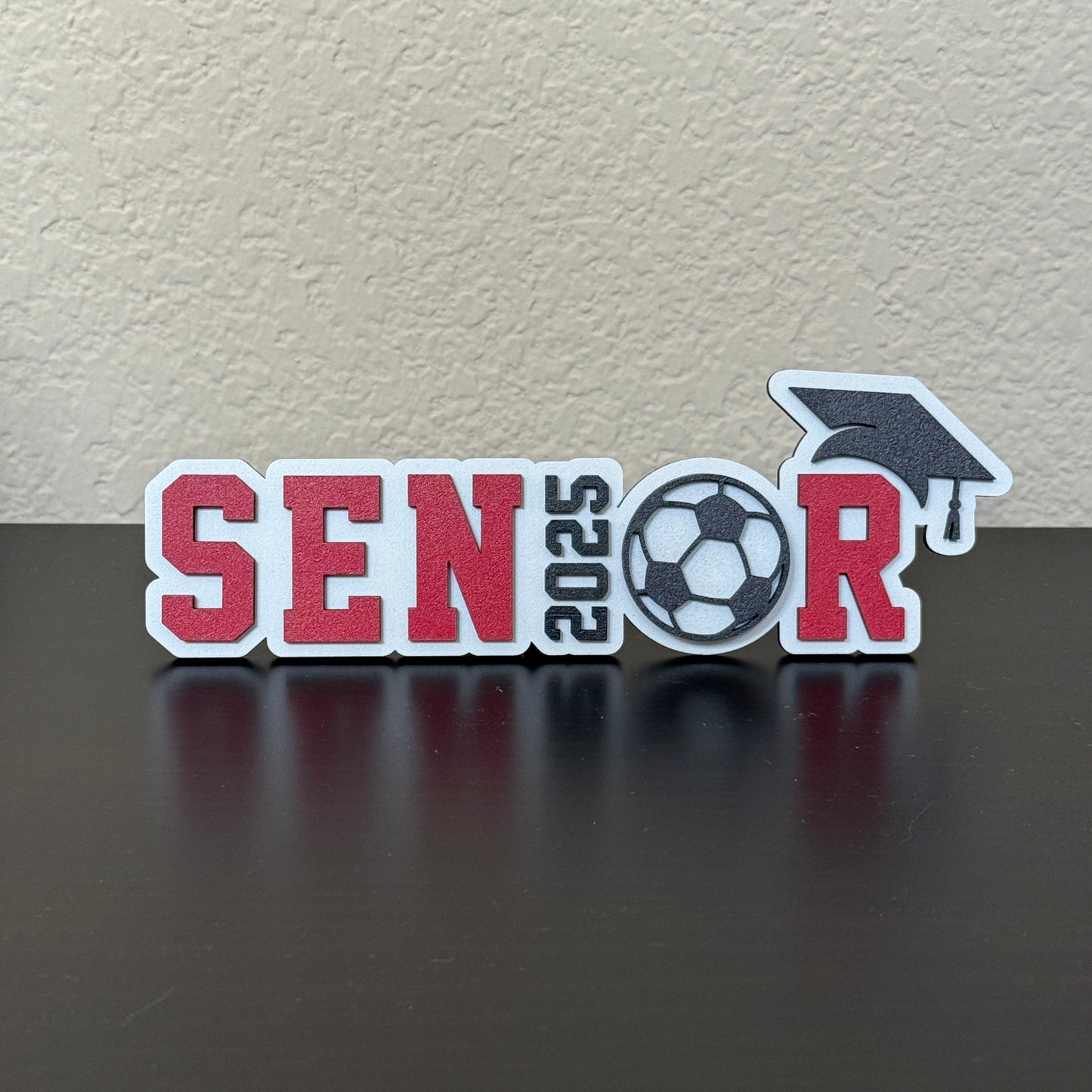 Class of 2025 senior soccer sign with a soccer ball design and graduation cap accent, tabletop decor for high school soccer graduation party or senior sports banquet