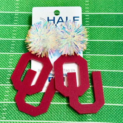 OU Game Day Dangle acrylic earrings in crimson with iridescent tinsel earring toppers. Officially Licensed University of Oklahoma Boomer Sooner earrings by Half Turn Designs.