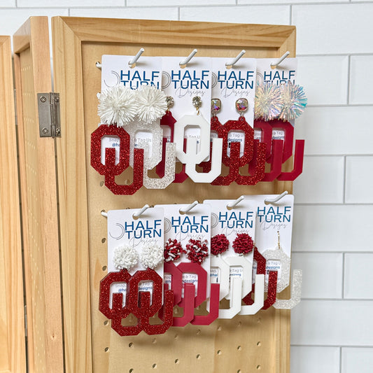 Officially Licensed University of Oklahoma Large OU Earrings in crimson, white, crimson glitter or white glitter acrylic by Half Turn Designs. Available in a variety of hypoallergenic earrings hooks and toppers.
