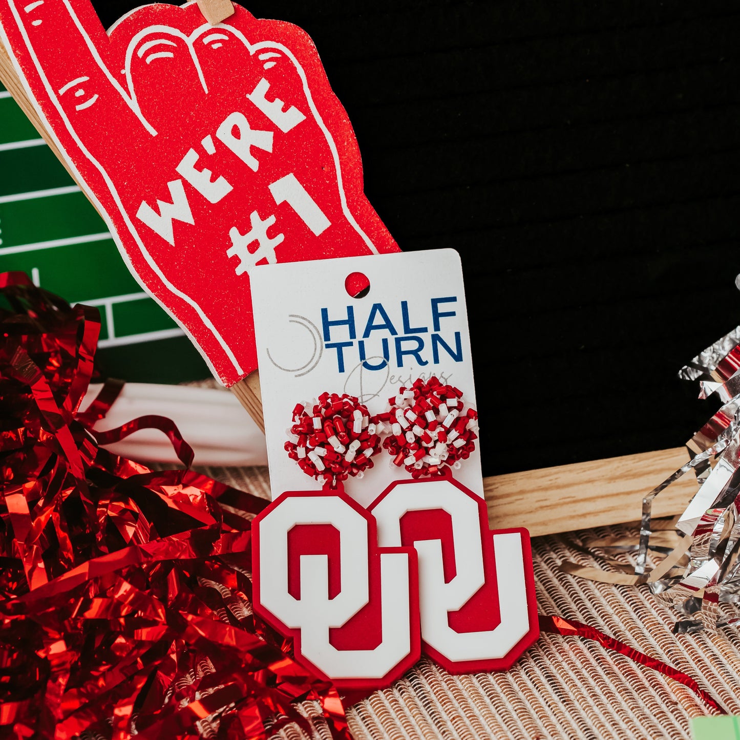 Officially licensed University of Oklahoma game day earring collection by Half Turn Designs. These earrings are available in combinations of crimson and white acrylic, including glitter. Available in a eight different fun toppers for OU game days and as a gift for your favorite Oklahoma Sooner.  White on Crimson with Crimson and White Bead Toppers shown here.
