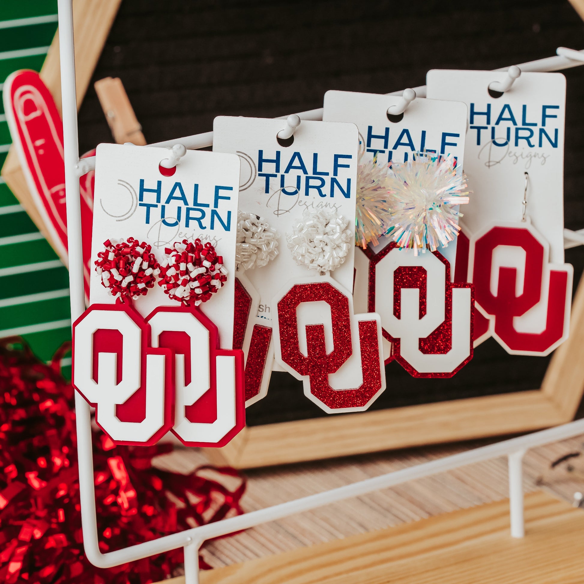 Officially licensed University of Oklahoma game day earring collection by Half Turn Designs. These earrings are available in combinations of crimson and white acrylic, including glitter. Available in a eight different fun toppers for OU game days and as a gift for your favorite Oklahoma Sooner.