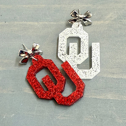 Officially Licensed University of Oklahoma Sooners Earrings in Crimson and White Glitter Acrylic, OU logo Boomer Sooner Game Day Jewelry for Students & Alumni in a variety of earring toppers including AB Iridescent Jewel, Rhinestone, Bows or Earring Hooks - all available in gold or silver finish.