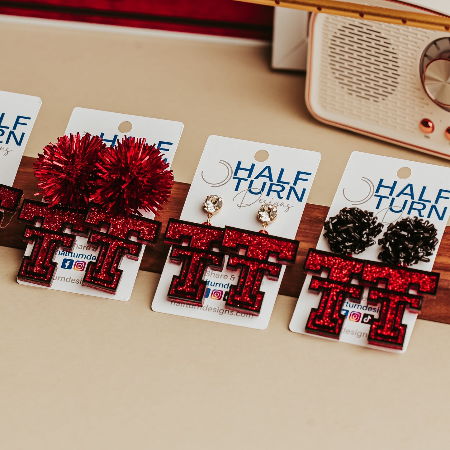 Collection of TTU Red glitter Texas Tech Double T earrings displayed on Half Turn Designs cards with multiple hook and topper styles.