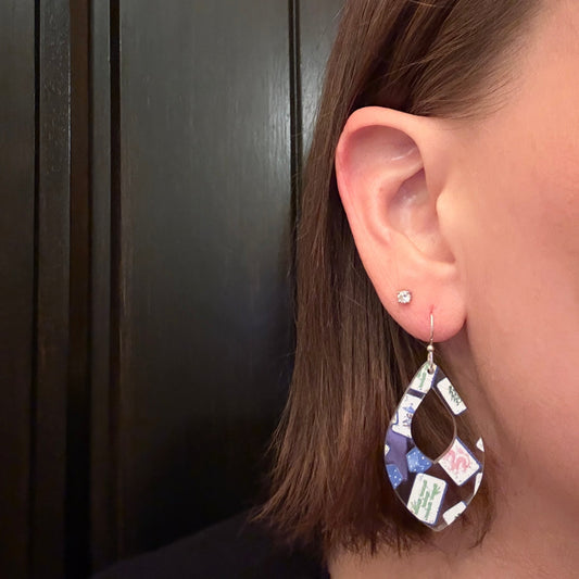 Model wearing Mahjong teardrop earrings with blue Chinoiserie mahjong tile and dice pattern, lightweight acrylic jewelry on silver hooks