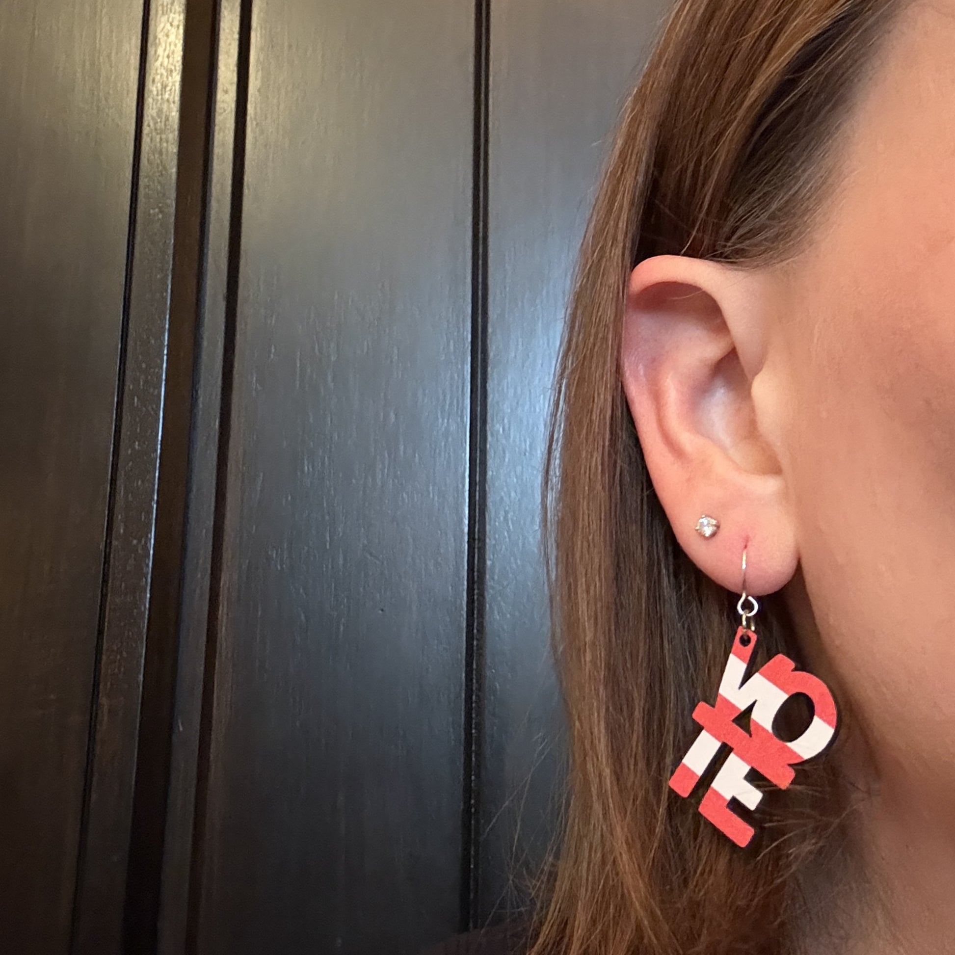 Model wearing American Flag Vote Earrings by Half Turn Designs