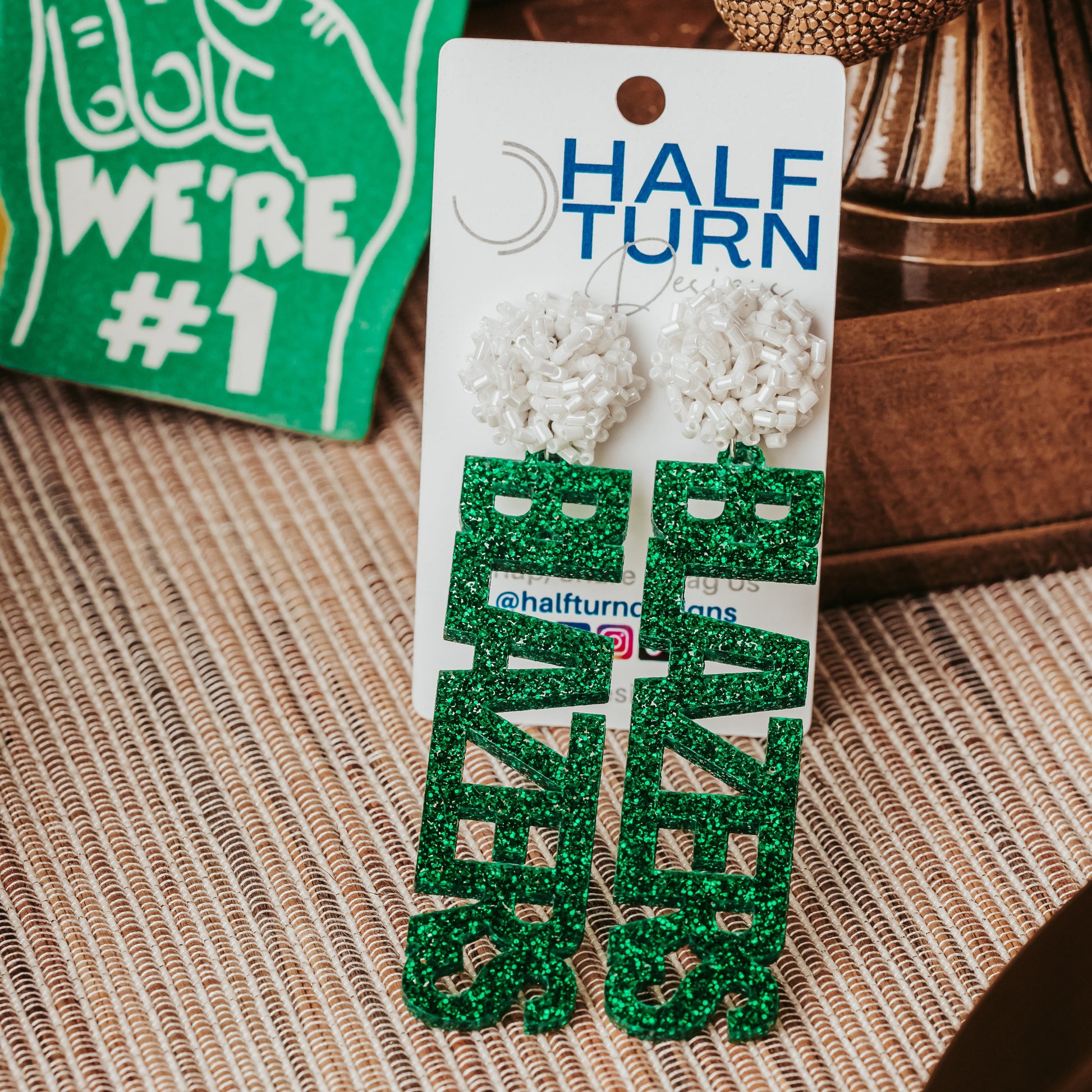 Officially Licensed University of Alabama Birmingham game day earrings in green and white glitter in your choice of 10 different earrings toppers by Half Turn Designs. White tube bead earring toppers shown here.