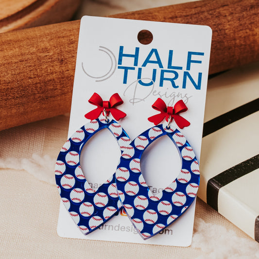 Blue baseball earrings with red bow tops and open teardrop shape by Half Turn Designs