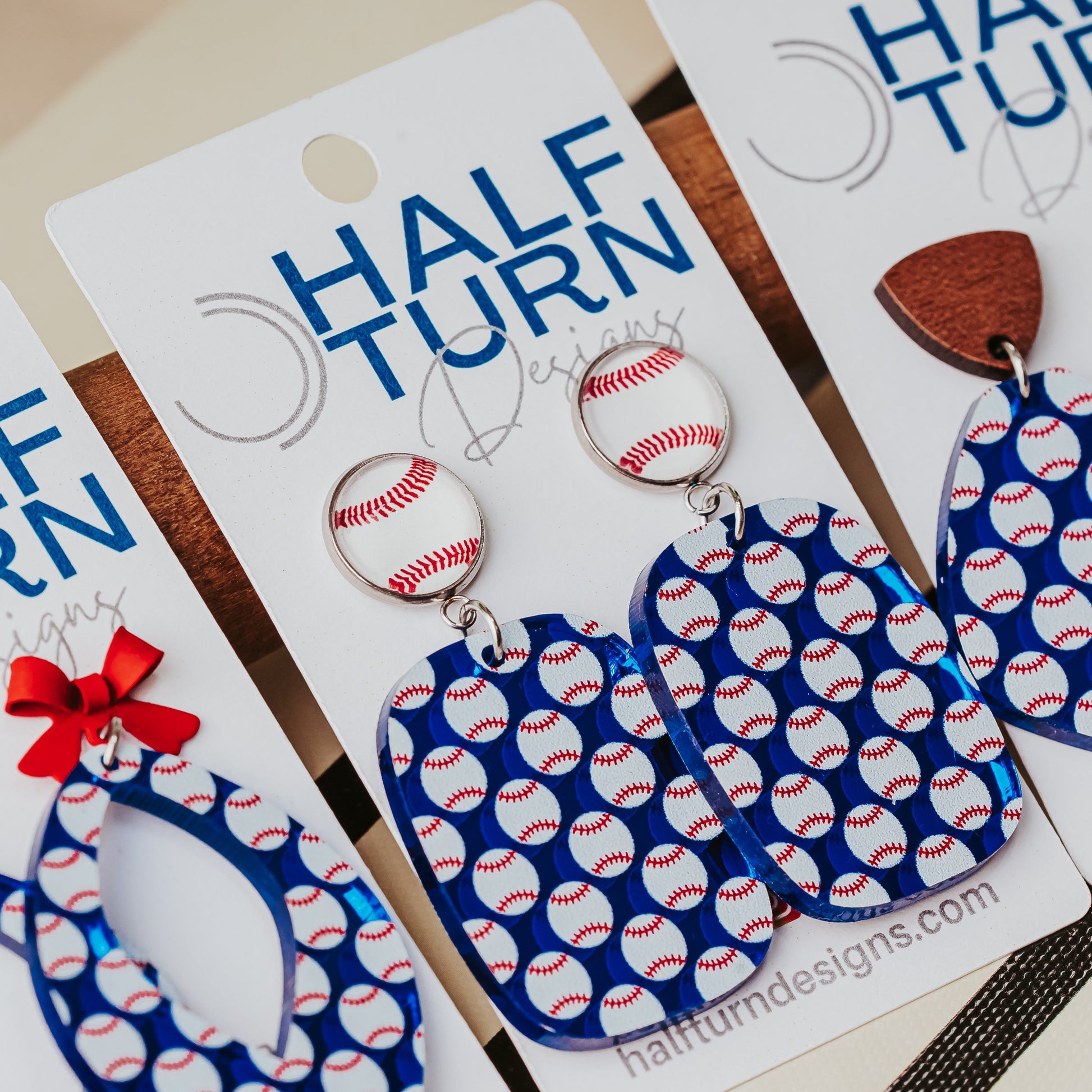Blue baseball earrings for women shown on display card with silver-toned settings