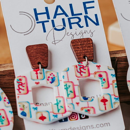 Colorful mahjong hexagon earrings made from lightweight printed acrylic with natural walnut wood studs by Half Turn Designs
