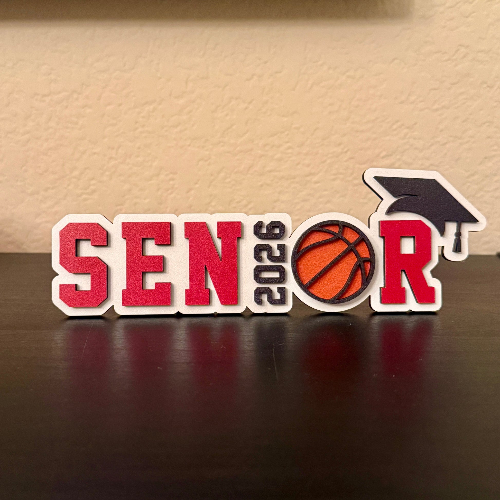 Class of 2026 senior basketball sign with basketball graphic and graduation cap. Shown here in red.  Graduation party and high school basketball banquet decor