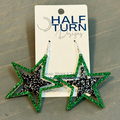 Green and black glitter stars earrings on silver hooks, lightweight acrylic dangles for game day, handmade in Texas by half turn designs