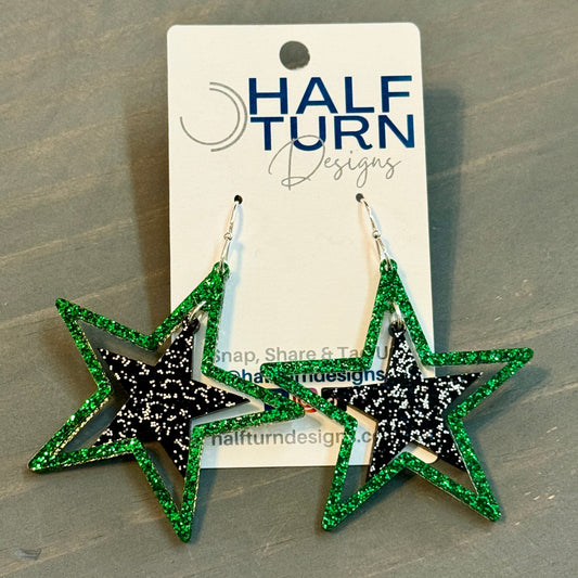 Green and black glitter stars earrings on silver hooks, lightweight acrylic dangles for game day, handmade in Texas by half turn designs