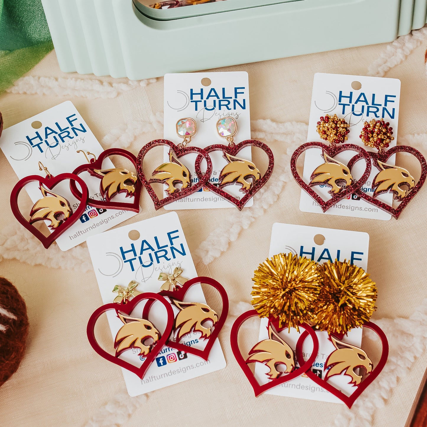 Half Turn Designs Collection of Texas State University Bobcats earrings in TXST Maroon and Gold acrylic.