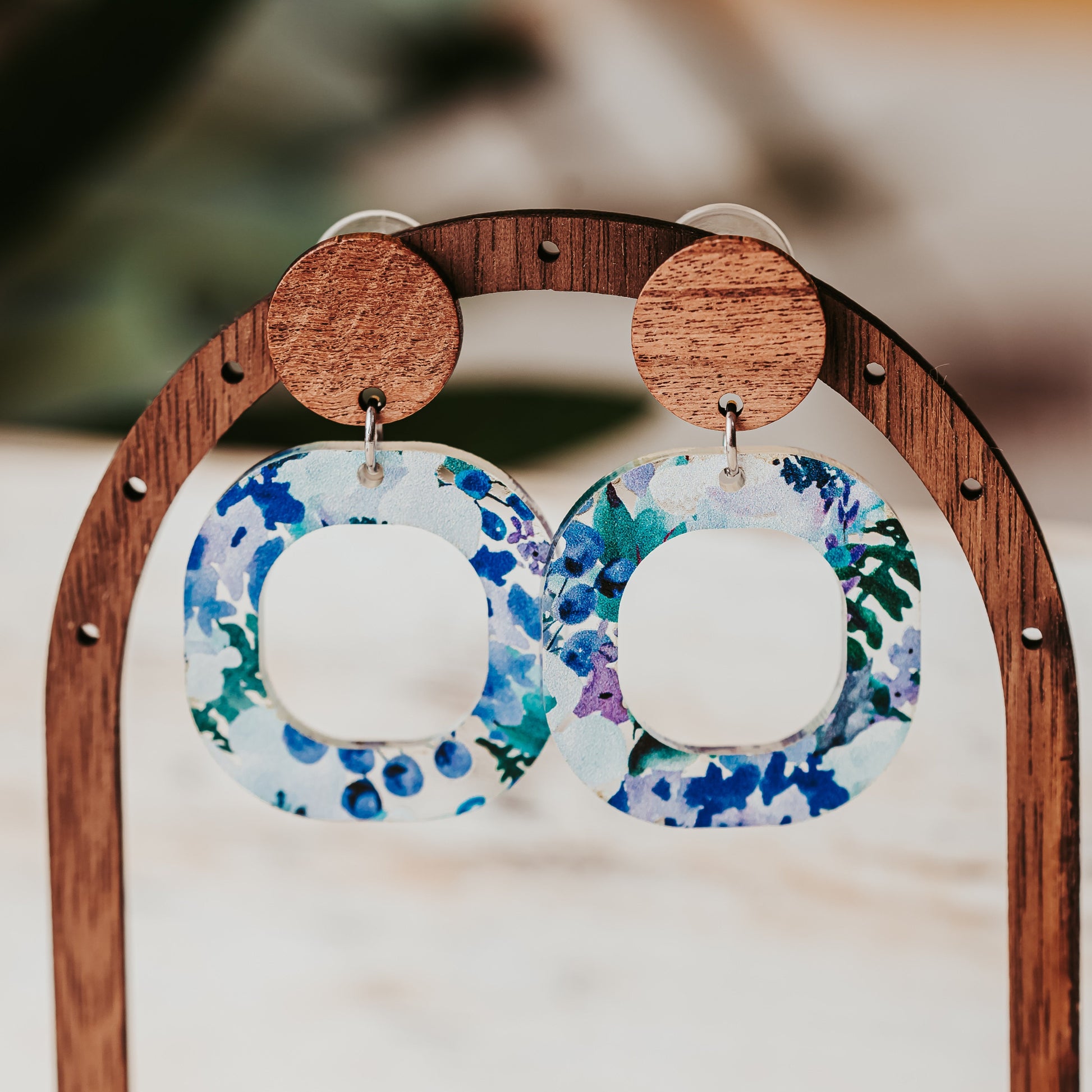 Handmade floral acrylic earrings with open square design and natural wood studs