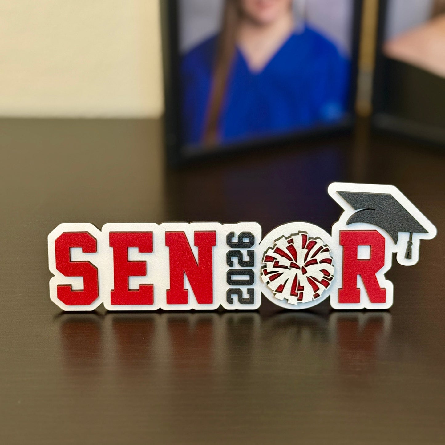 High School Senior Cheerleader graduation party decoration for the class of 2026. Shown here in white with red accents.