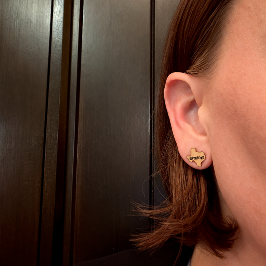 Model wearing Pair of gold-tone Texas Tech Wreck 'Em studs 