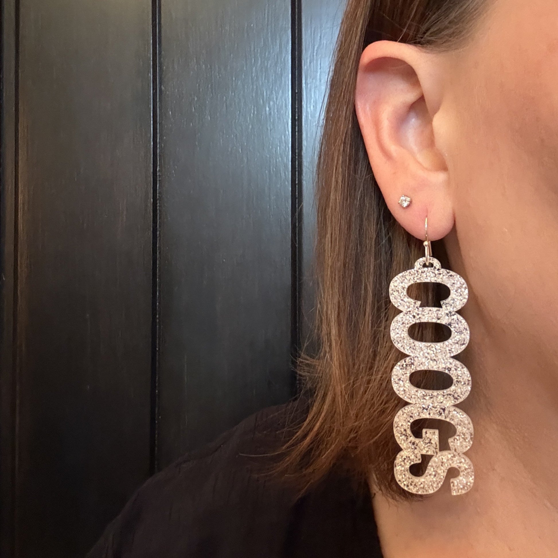 Model wearing University of Houston COOGS earring collection in white glitter with hypoallergenic stainless steel earring hooks by Half Turn Designs