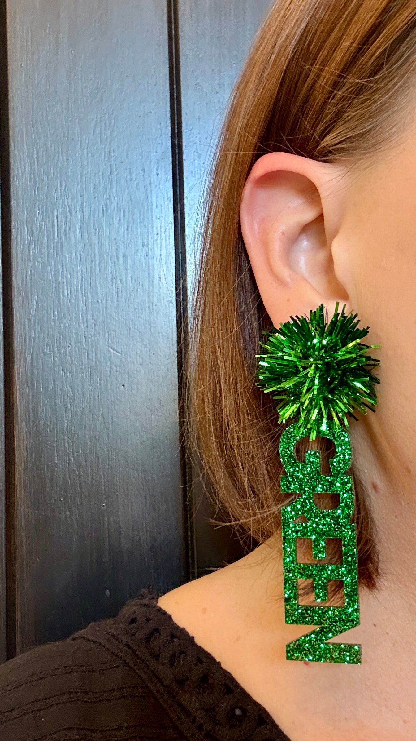Officially licensed University of North Texas Mean Green Game Day earrings in green and white glitter with your choice of earrings topper including silver earring hooks, rhinestone topper, white tube bead topper, green tinsel topper, iridescent tinsel topper or white tinsel topper.