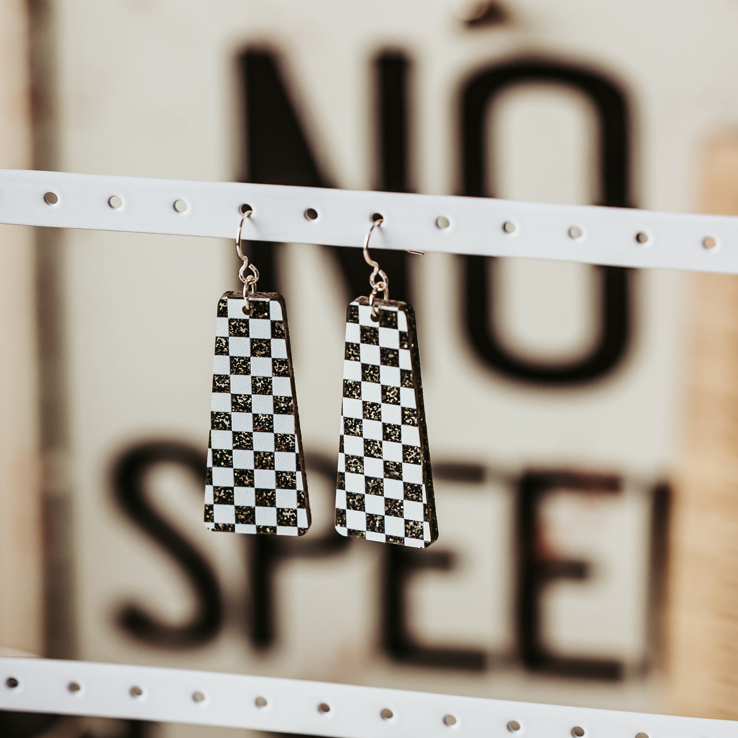motorsport earrings in black white checkered pattern