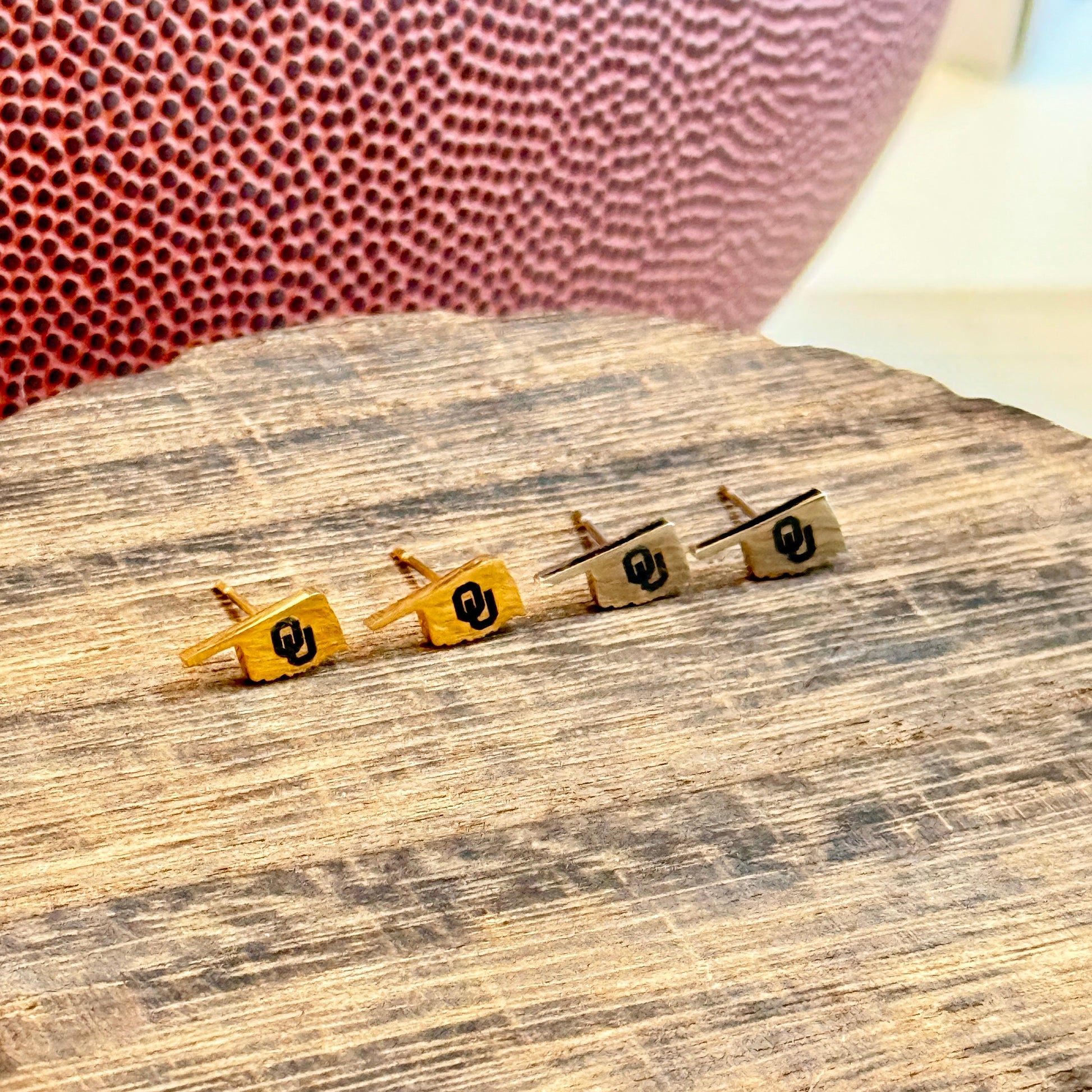 Officially licensed University of Oklahoma hypoallergenic stainless steel earring studs in gold or silver tones.