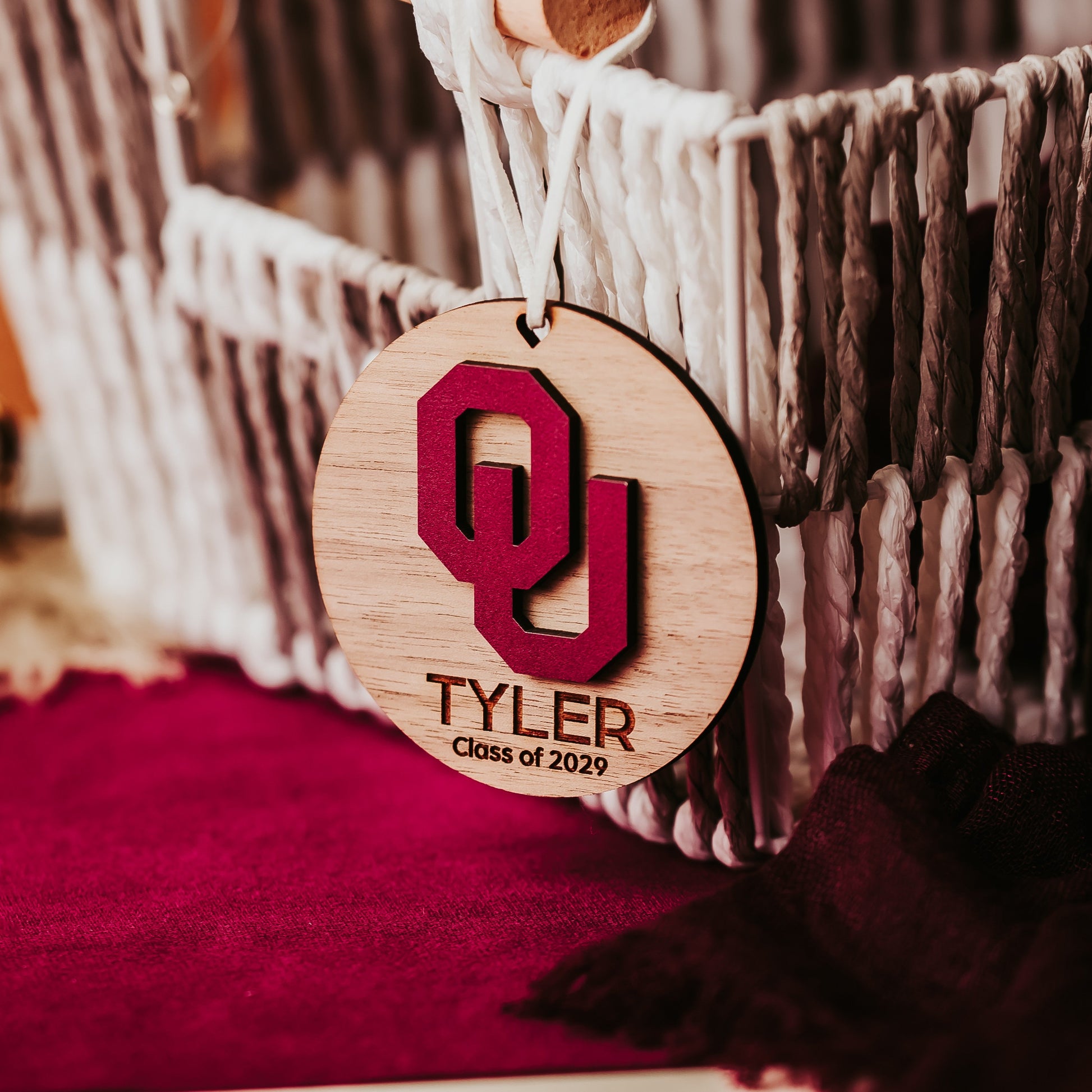 Engraved University of Oklahoma ornament featuring crimson OU logo on 3-inch round wood ornament, customizable with name or phrase, available in Cherry, Mahogany, Walnut, Sapele, or White finishes. Perfect Sooner Christmas gift or car charm. Shown here in walnut.;