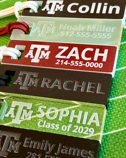 Officially licensed Texas A&M luggage and bag tags in rectangular shape, measuring 2.75x0.75".  These acrylic luggage and bag tags are personalized with 1-2 lines of text and come in 1/8" or 1/4" width.  Luggage tag colors include Clear, Frosted, Opaque Black, Shiny Black, Maroon that engraves white and Black that engraves white.