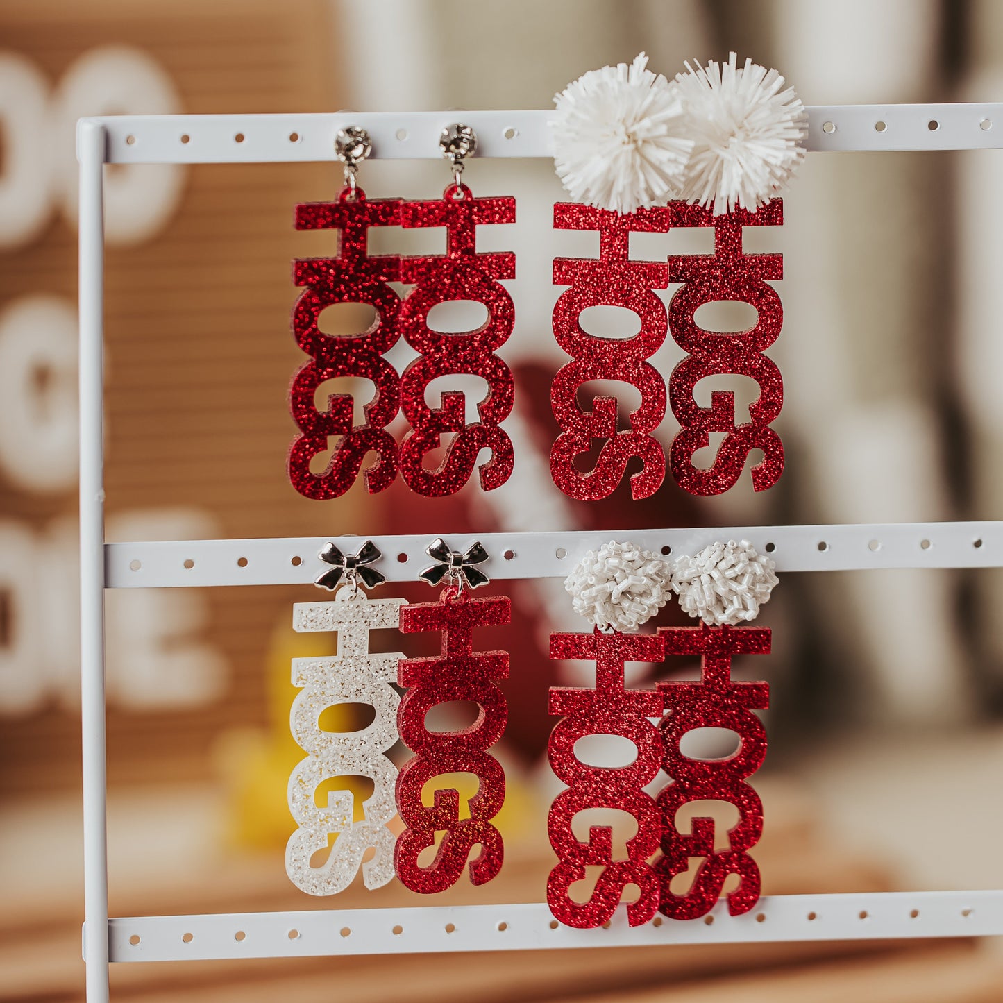 Officially licensed University of Arkansas HOGS game day dangle earrings in crimson and white glitter acrylic by Half Turn Designs.