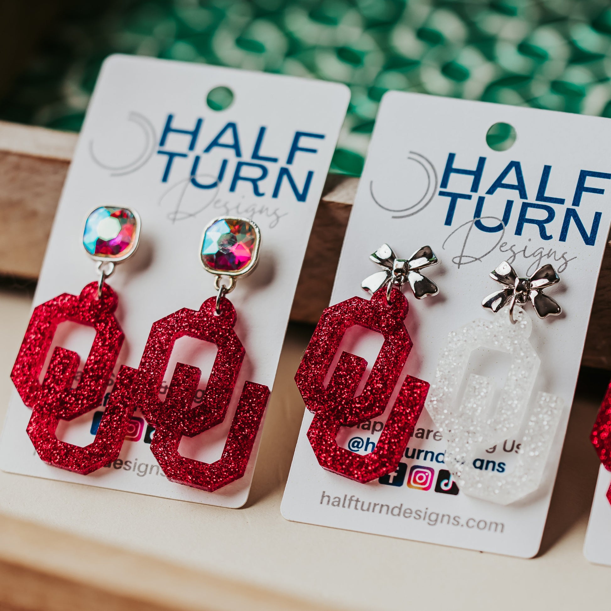 Officially Licensed University of Oklahoma Sooners Earrings in Crimson and White Glitter Acrylic, OU logo Boomer Sooner Game Day Jewelry for Students & Alumni in a variety of earring toppers including AB Iridescent Jewel, Rhinestone, Bows or Earring Hooks - all available in gold or silver finish.