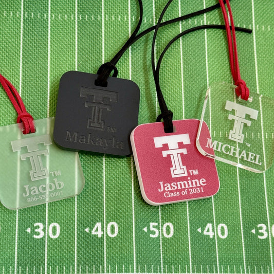 Personalized Texas Tech luggage tags featuring the updated Double T logo in 1/4" acrylic. Shown here in Frosted, Opaque Black, TTU Red and Clearn