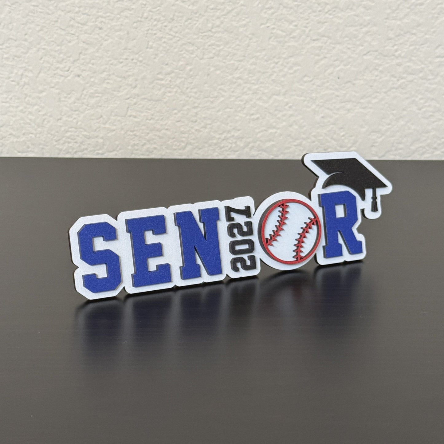 Side view of a Senior 2027 wood baseball graduation sign with blue and white lettering and baseball detail