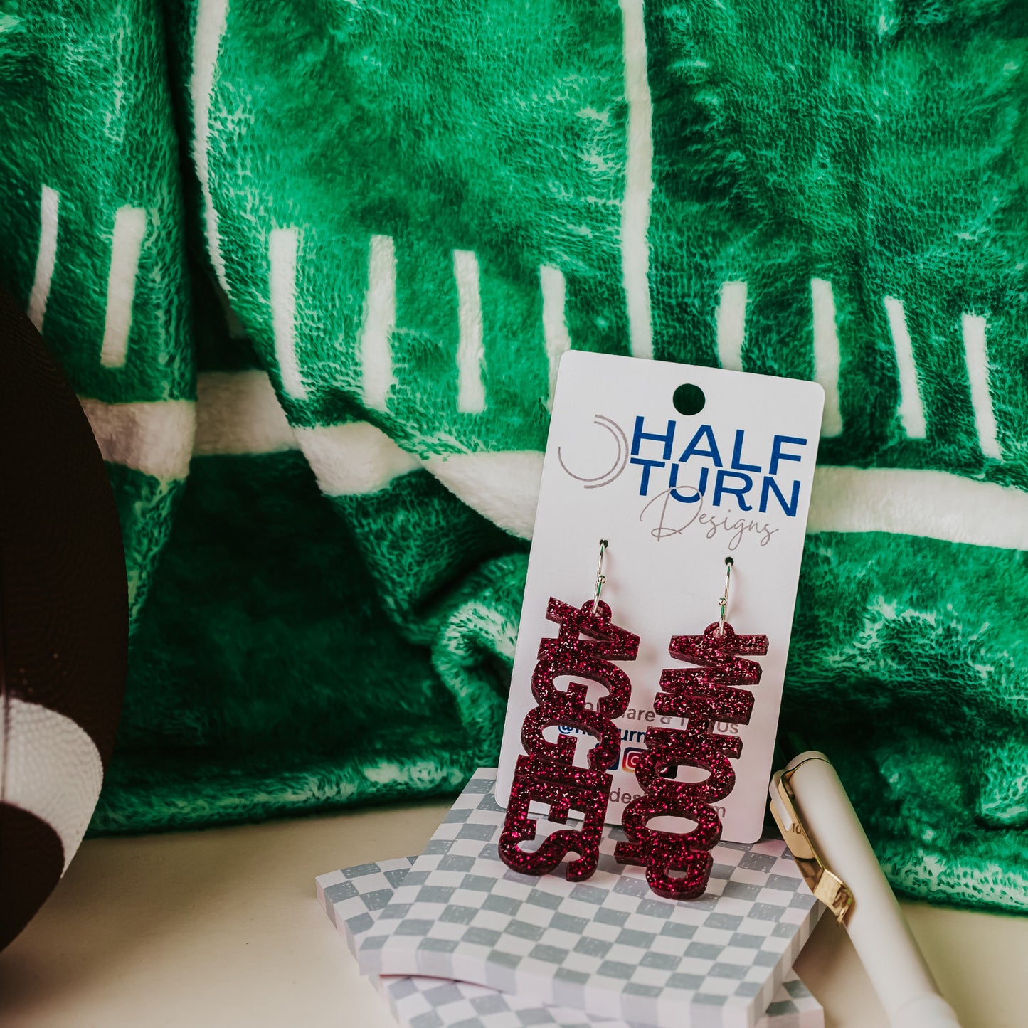 Officially licensed Texas A&M Aggie and Whoop dangle earrings in maroon glitter with silver earring hooks.
