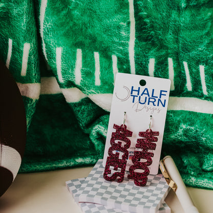 Officially licensed Texas A&M Aggie and Whoop dangle earrings in maroon glitter with silver earring hooks.