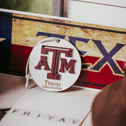 Texas A&M personalized wooden ornament. Available in four wood types - Cherry, Mahogany, Walnut and White wood. Officially licensed by Half Turn Designs.  Shown here in White wood
