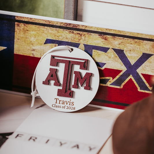 Texas A&M personalized wooden ornament. Available in four wood types - Cherry, Mahogany, Walnut and White wood. Officially licensed by Half Turn Designs.  Shown here in White wood