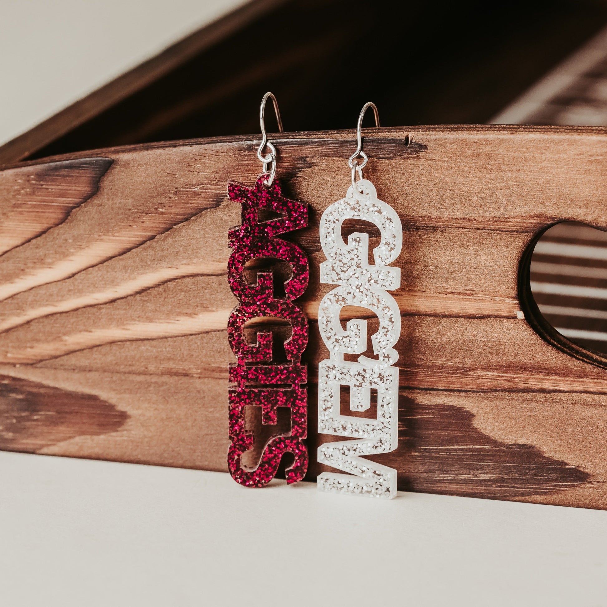 Texas A&M University mini mix & match dangles earrings in maroon and white glitter.  Phrases available include aggies, gig 'em, howdy and whoop