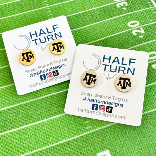 Texas A&M stud earrings engraved with the TAMU logo. The handmade earrings by Half Turn Designs are circular, 12mm in size and made from hypoallergenic Stainless Steel in gold or silver finish.
