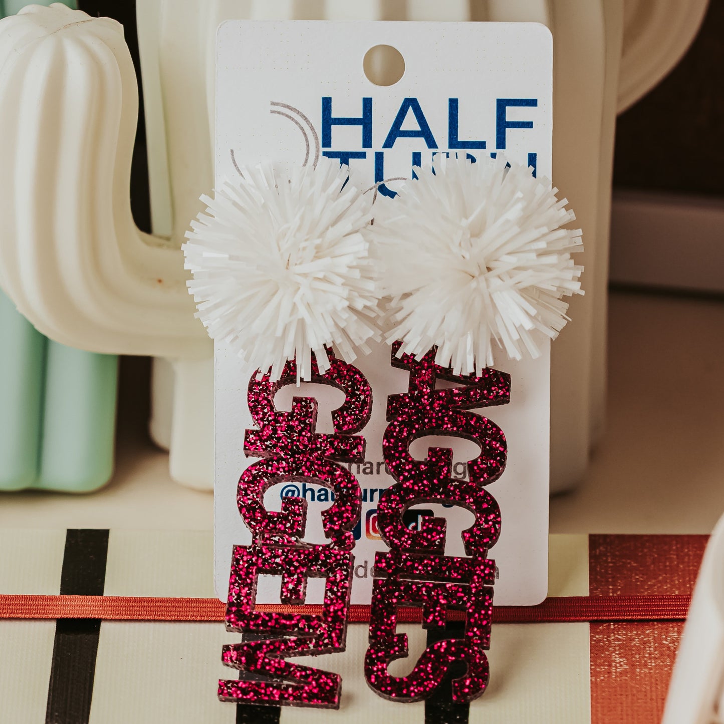 Texas A&M Officially Licensed Mix and Match Dangle earrings. Both of these earrings are in maroon glitter, the first spelling "Gig'em" and the second spelling "Aggies" with a white tinsel topper.