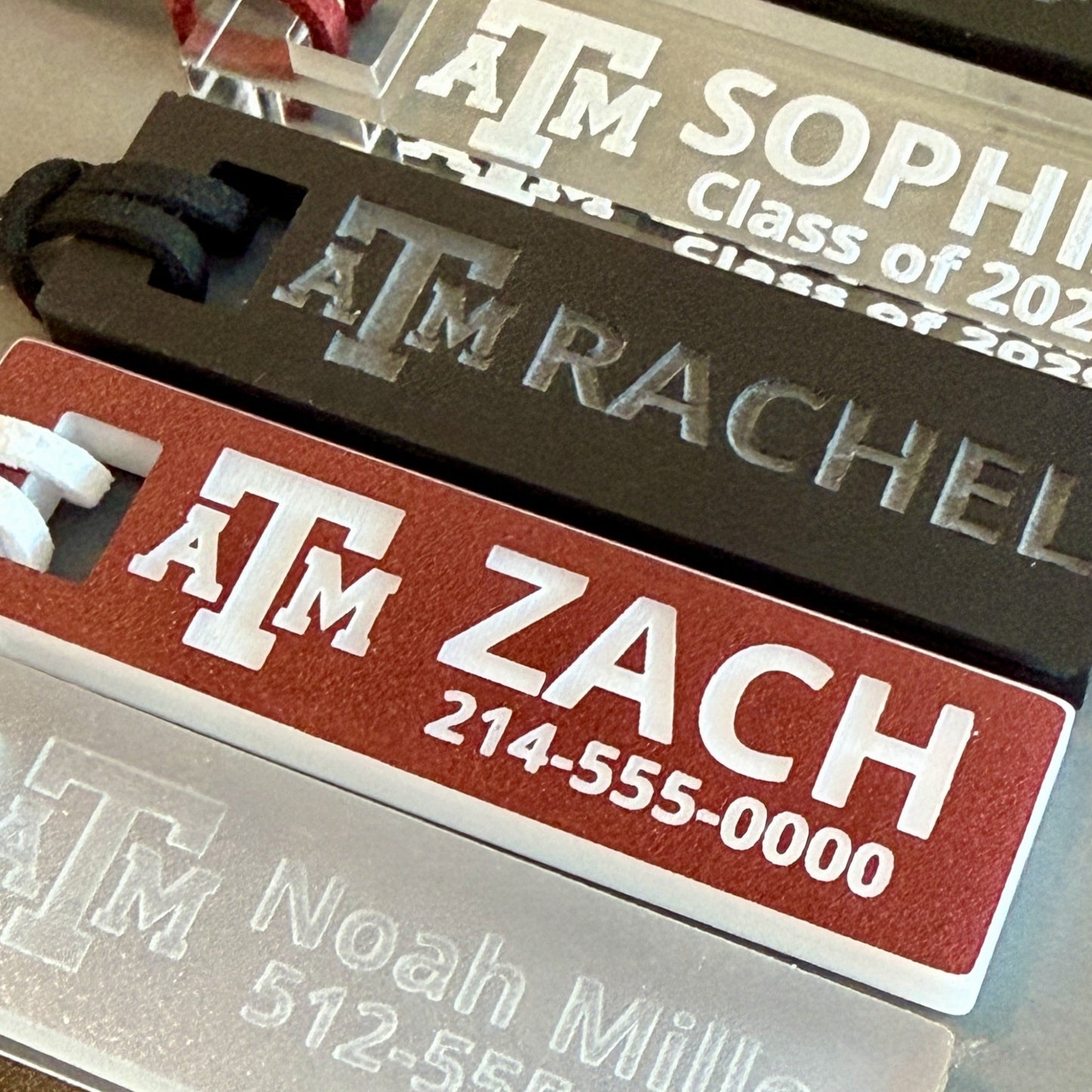 Officially licensed Texas A&M luggage and bag tags in rectangular shape, measuring 2.75x0.75".  These acrylic luggage and bag tags are personalized with 1-2 lines of text and come in 1/8" or 1/4" width.  Luggage tag colors include Clear, Frosted, Opaque Black, Shiny Black, Maroon that engraves white and Black that engraves white.