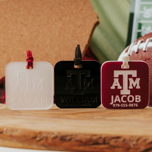 Officially licensed Texas A&M luggage tags in square shape, 2x2".  These acrylic luggage tags are personalized with 1-2 lines of text and come in 1/8" or 1/4" width.  Luggage tag colors include Clear, Frosted, Opaque Black, Shiny Black, Maroon that engraves white and Black that engraves white.