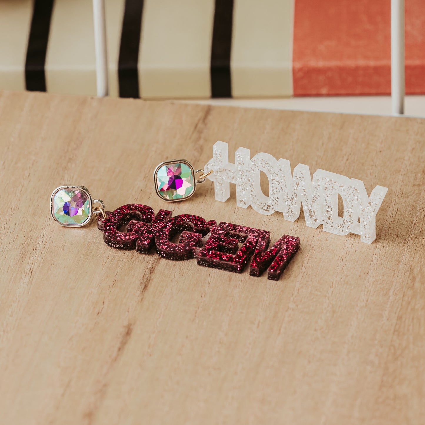 Texas A&M Officially Howdy and Gig'em dangle earrings in maroon and white glitter acrylic with AB Iridescent stud toppers.