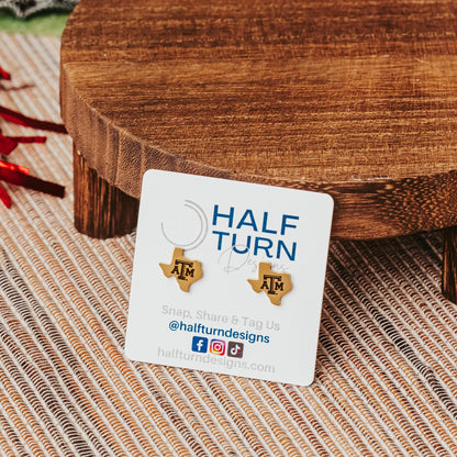 Petite Texas A&M Studs made from stainless steel in gold or silver finish featuring the TAMU logo. Shown here in gold finish.
