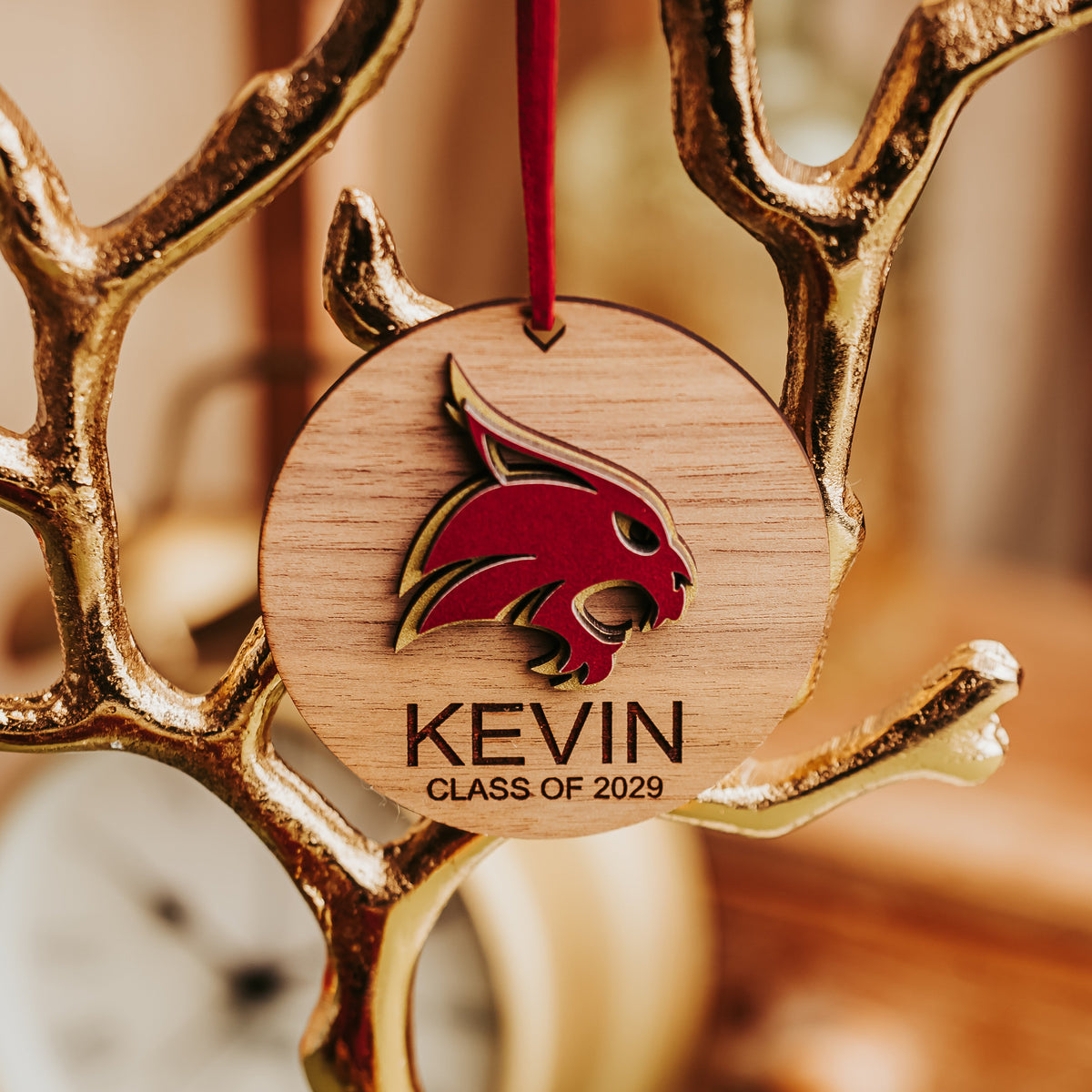 Walnut wood Texas State ornament with a raised maroon and gold Bobcat, engraved Kevin, Class of 2029
